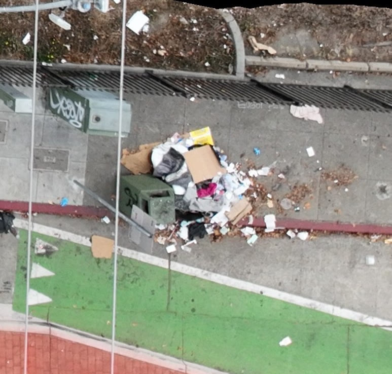 Aerial view of an illegal dumping pile on an Oakland sidewalk